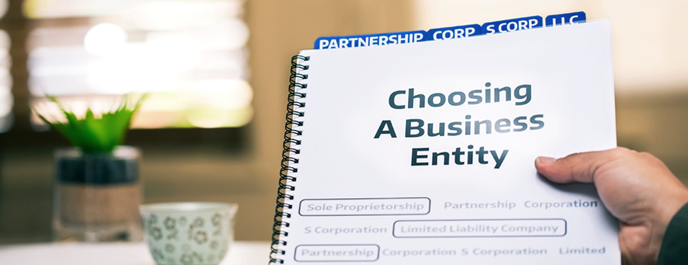 hand holding a guide document about different business entities, such as c corporations (or c corps) and s corporations (or s corps)