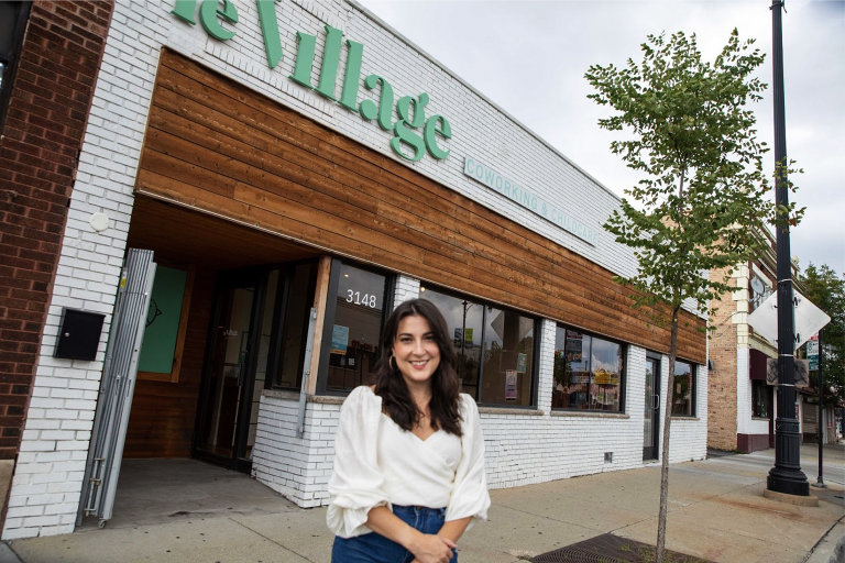 Business owner Daniella Cornue standing outside of Le Village in Irving Park, Chicago.