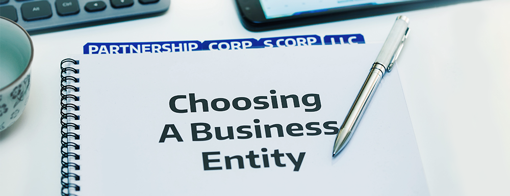 A notebook reads "Choosing a Business Entity" with S Corps as a tab, can help with going from S Corp to C Corp.
