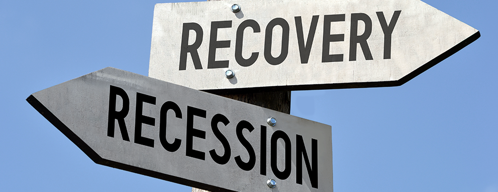 Two signs facing different directions (one to the left: "Recession" and one to the right, "Recovery." Header forrecession proof business strategies article.