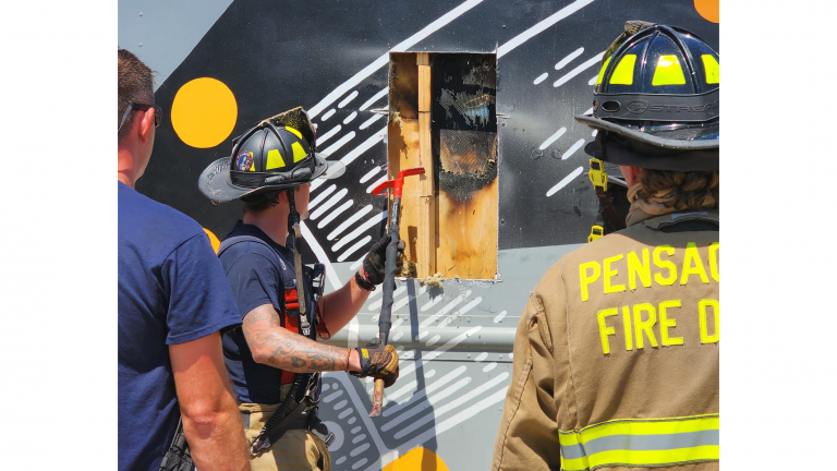 Firemen surgically remove a piece of metal from the food truck to get inside and extinguish the fire.