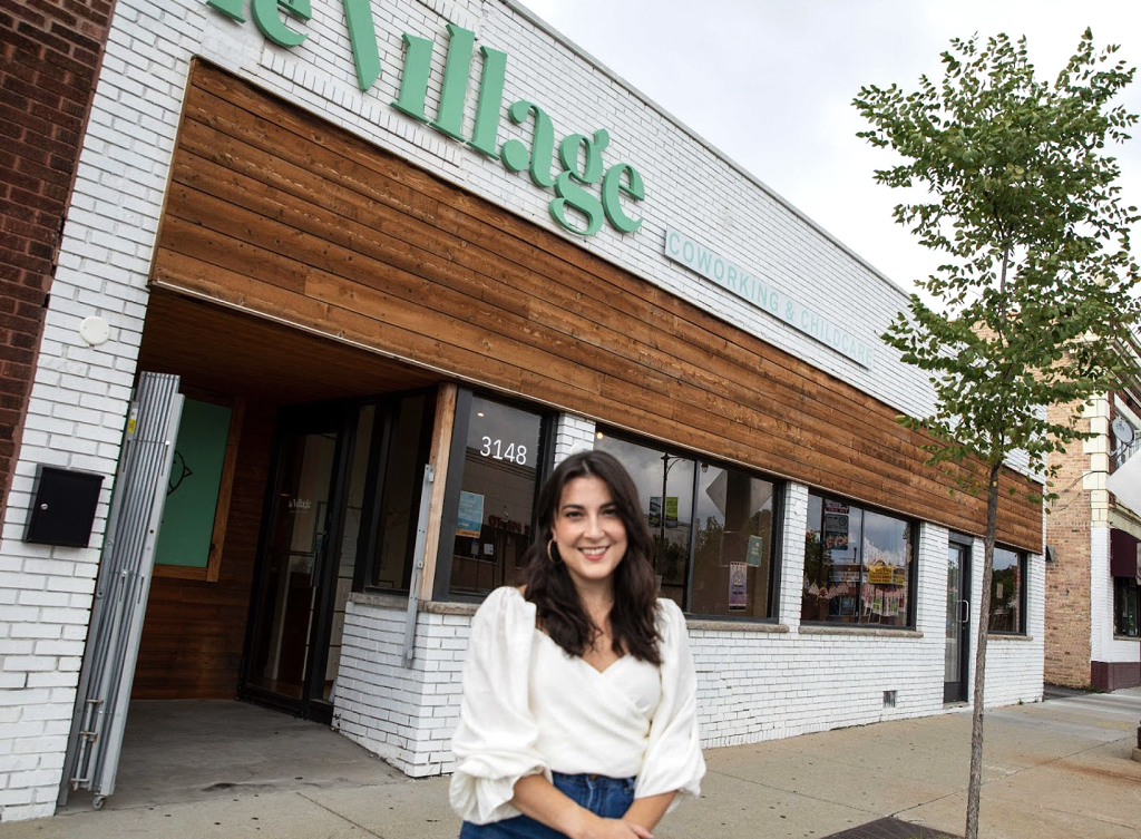 Daniella Cornue, Hispanic business owner of Le Village Cowork, standing outside of her business. (Top Resources and Grants for Hispanic Entrepreneurs - Guidant Financial Blog).