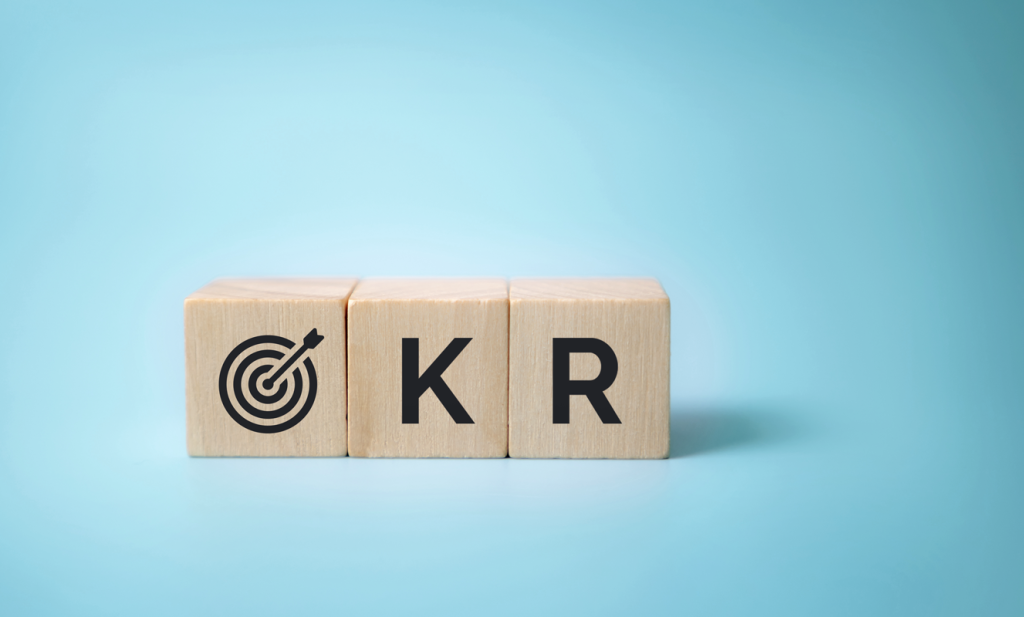 Blocks that spell out "OKR" with the "O" as a target. (How to Build a Brand and Measure OKRs Blog.)