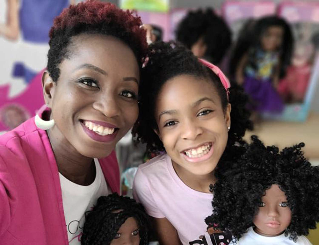 Photo of Evana (left) and Zoe Oli (right), the mother-and-daughter duo and owners of Beautiful Curly Me. (Inspiring Small Businesses to Celebrate - Guidant Blog.)