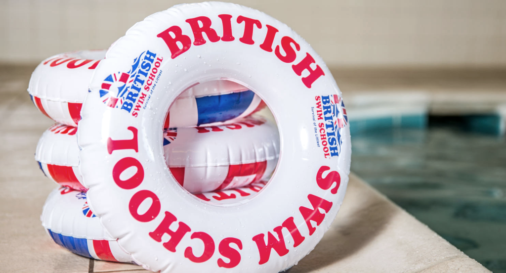 British Swim School logo printed on pool floats next to a swimming pool. Photo by https://britishswimschool.com. (Top 10 Summer Franchises - Guidant). 