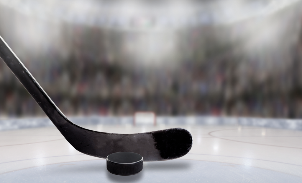 Hockey stick and puck on ice. (Boost Your Small Business with the Power of Hockey Stick Growth in 7 Steps - Guidant).