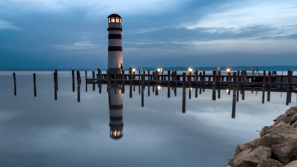 Lighthouse scenic view on a blue night, representing Safe Harbor 401k plans. (Demystifying Top Heavy 401k Plans: What You Need to Know - Guidant Blog.)