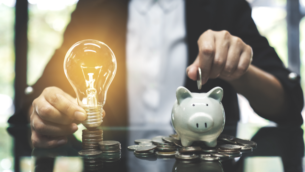 Man holding a lightbulb and piggy bank. (Maximizing Your Retirement: ROBS Investment Insights - Guidant Blog).