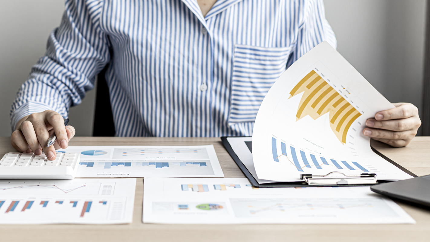 Man going through financial work. (Complete Guide to Bookkeeping - Guidant Financial).