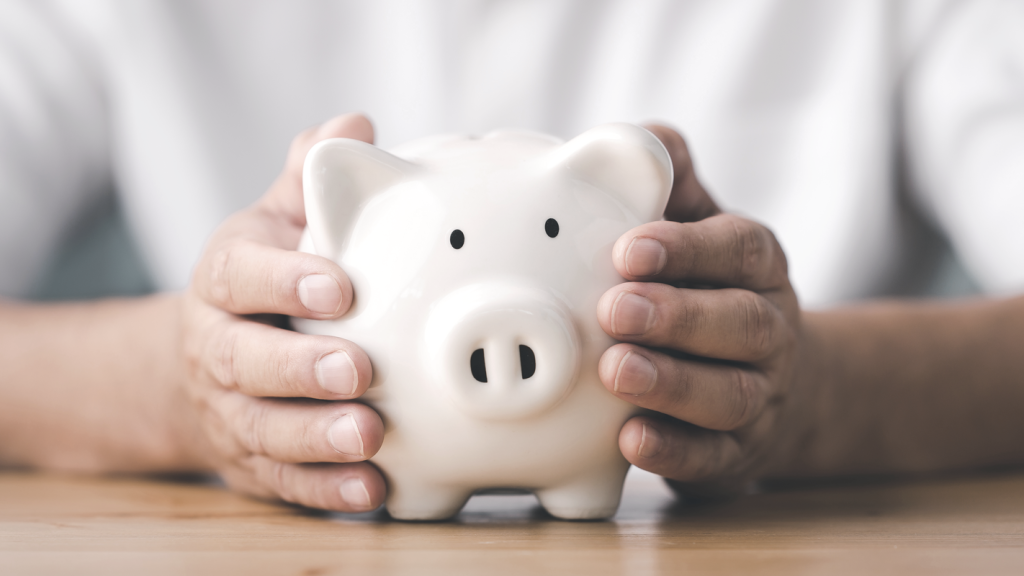 Hands holding a piggy bank. (Debunking 13 of the Biggest Myths About ROBS - Guidant Blog.)