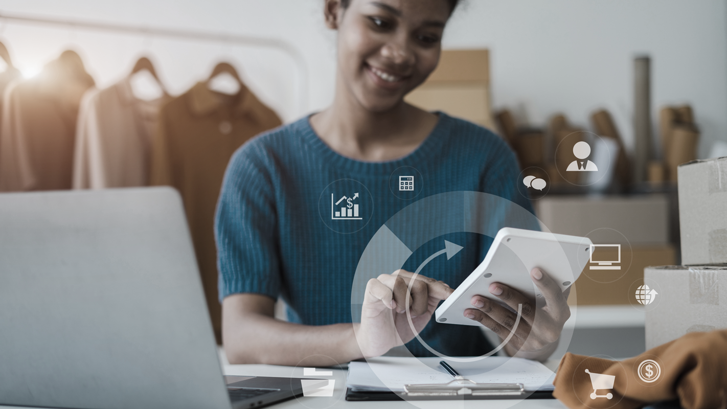 Woman holding calculator. (Complete Guide to Bookkeeping - Guidant Financial).
