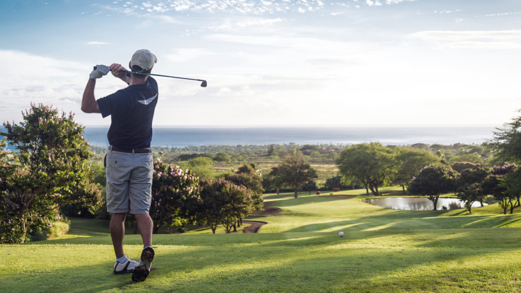 Man golfing outside on a sunny day. (3 Awesome Benefits of Business Ownership - Guidant Blog.)