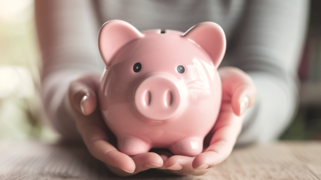 Hands holding a piggy bank. (Questions to ask When Choosing Small Business Funding - Guidant Blog.)