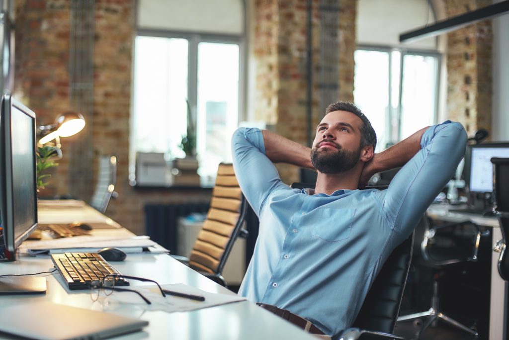 Man day dreaming in an office space. 